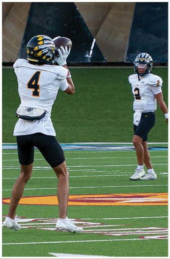 A football player running on the field. Description generated by AI