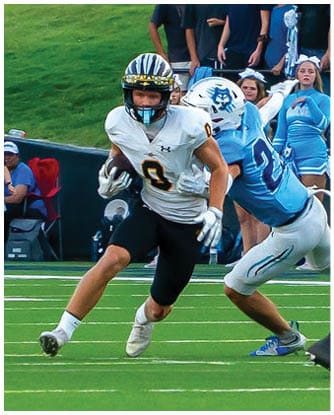 A football player running on the field. Description generated by AI