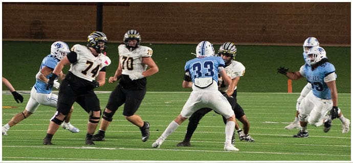 A football player is sliding on the ground. Description generated by AI