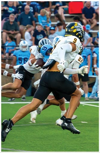 A football player running on the field. Description generated by AI