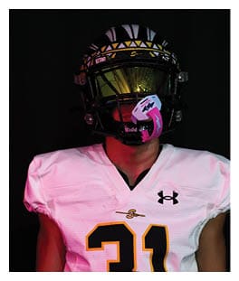 Two football players wearing black jerseys and holding hands. Description generated by AI