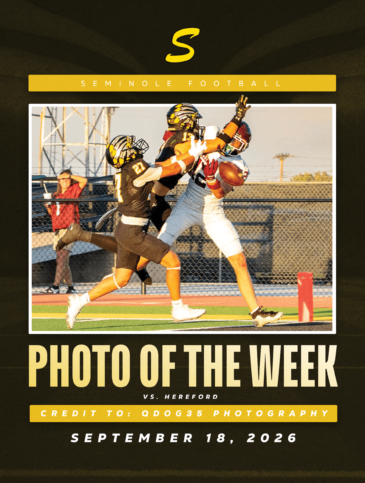 Two people in football uniforms compete to catch a football near the end zone during a game at sunset. Description generated by AI