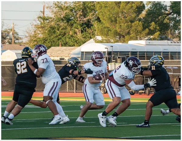 A group of football players on a field. Description generated by AI