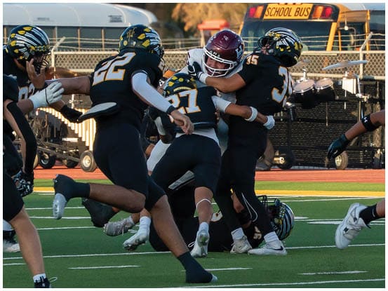 A football player is sliding on the ground. Description generated by AI