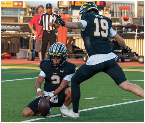 A football player running on the field. Description generated by AI