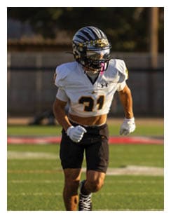 Two football players wearing black jerseys and holding hands. Description generated by AI