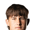 Person with curly hair and light eyes looking forward against a white background. Description generated by AI