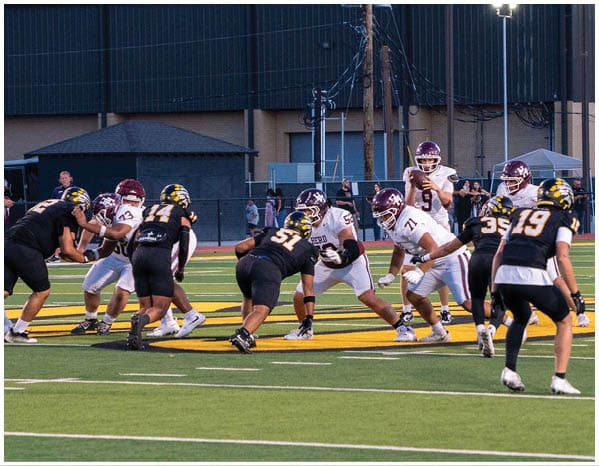 A group of football players on a field. Description generated by AI