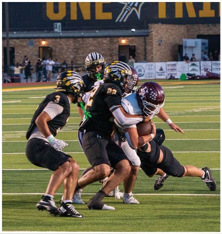 A football player running on the field. Description generated by AI