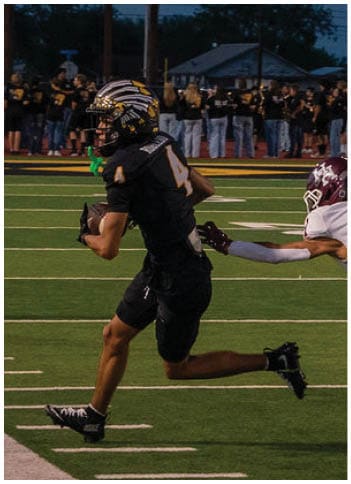 A football player running on the field. Description generated by AI
