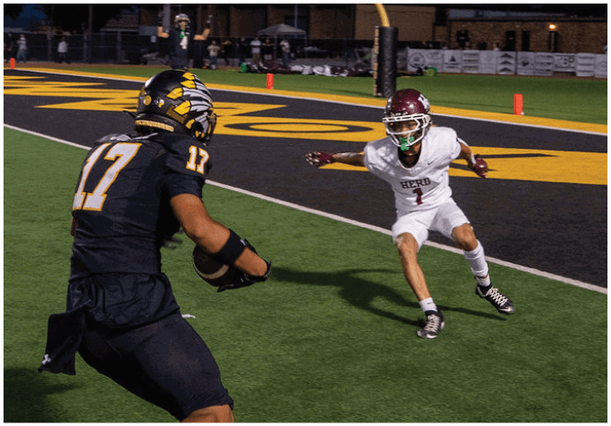 A group of football players wearing black and white uniforms. Description generated by AI