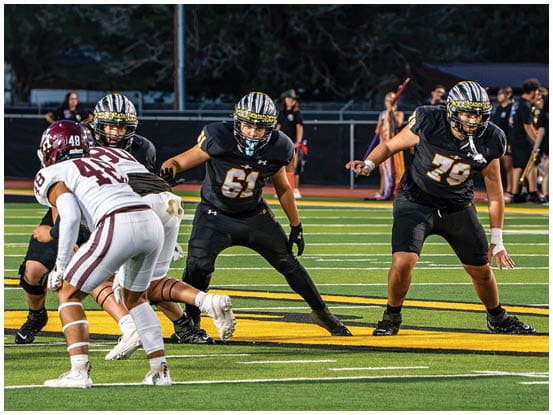 A football player is sliding on the ground. Description generated by AI