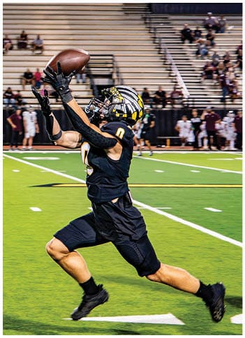 A football player running on the field. Description generated by AI
