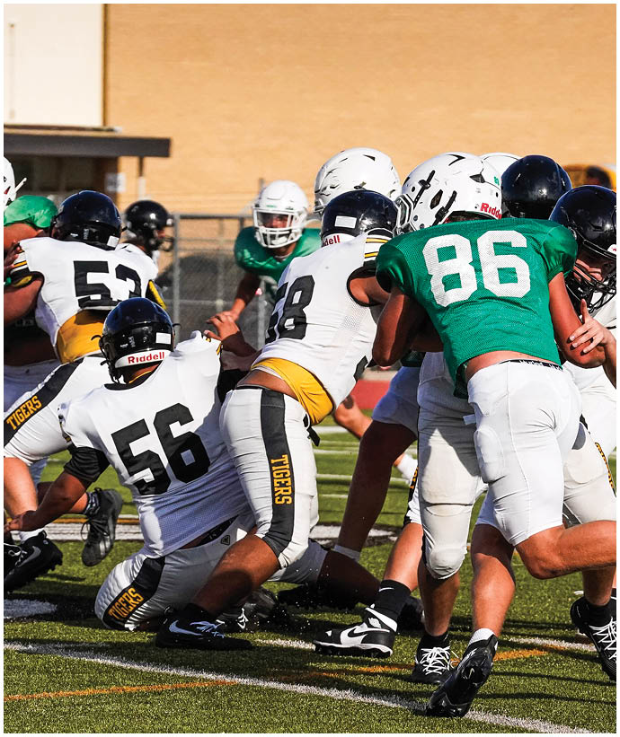 A group of football players wearing black and white uniforms. Description generated by AI