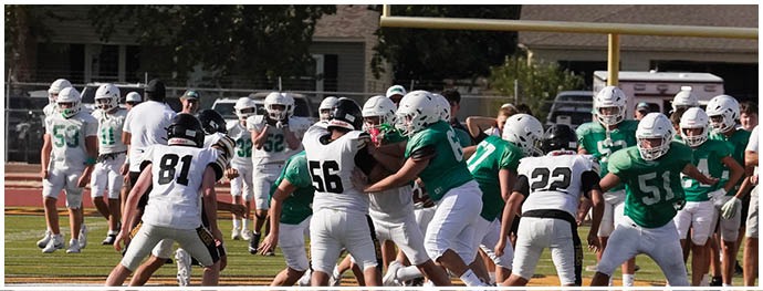 A football player is sliding on the ground. Description generated by AI