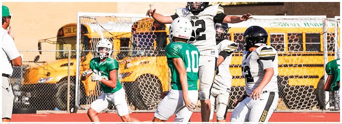A group of football players in blue and white uniforms. Description generated by AI