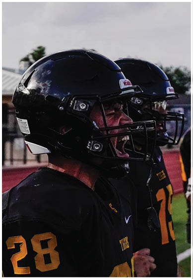 A football player wearing a blue jersey with the number 58 on it. Description generated by AI