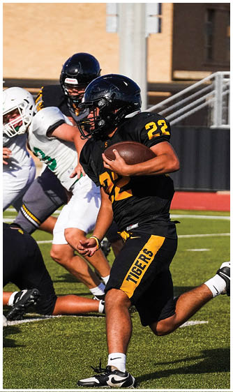 Two football players wearing blue and white uniforms. Description generated by AI
