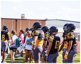 A football game is taking place with players on the field. Description generated by AI