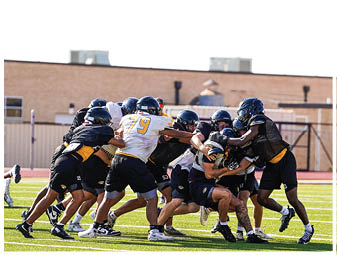 A group of football players on a field. Description generated by AI
