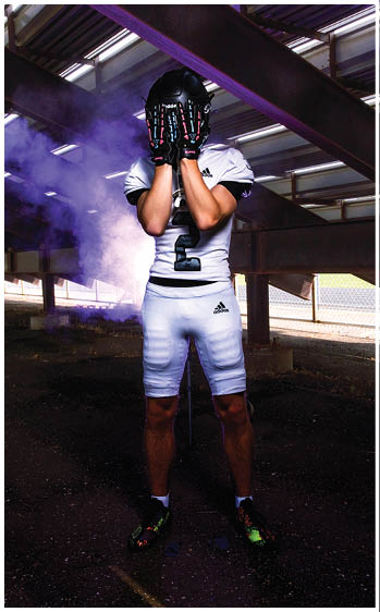 A football player running on the field. Description generated by AI