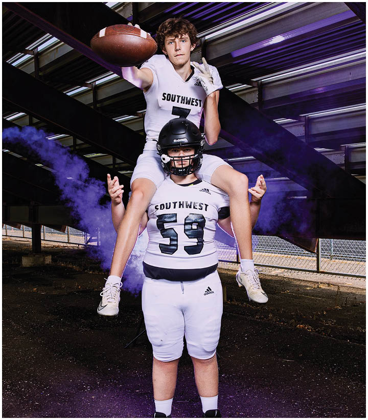 A group of football players wearing black and white uniforms. Description generated by AI