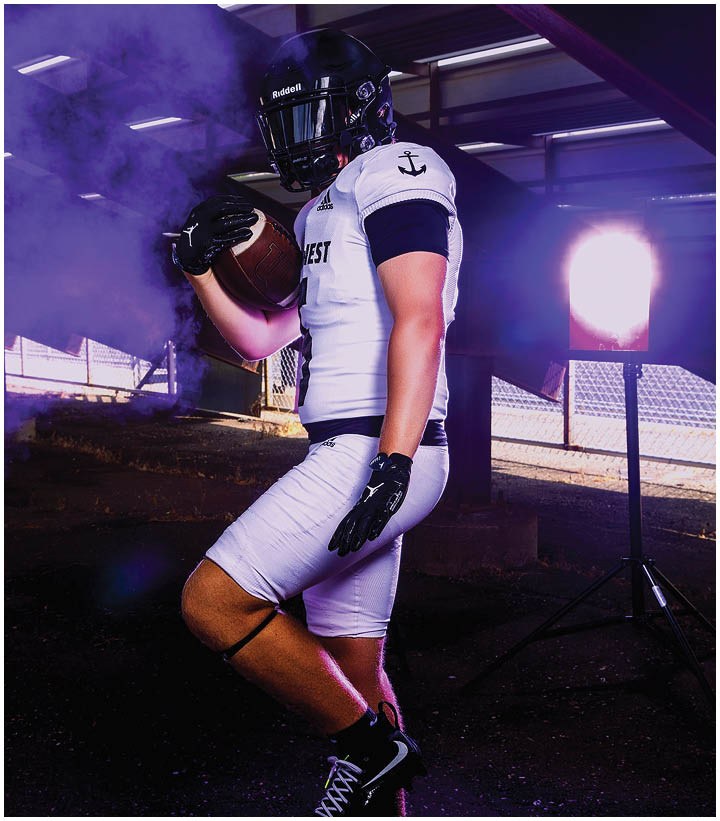 A group of football players wearing black and white uniforms. Description generated by AI