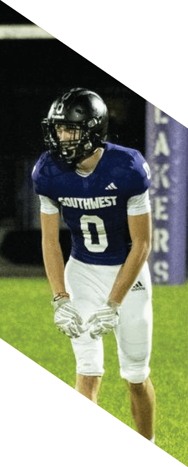 A football player wearing a helmet and white uniform is holding his helmet above his head. AI generated content