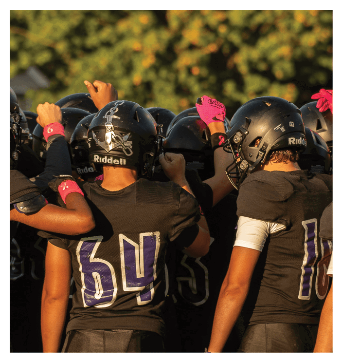 A group of football players walking on the field. AI generated content