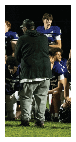 A football player is kneeling on the field, wearing a green jersey and a helmet. AI generated content