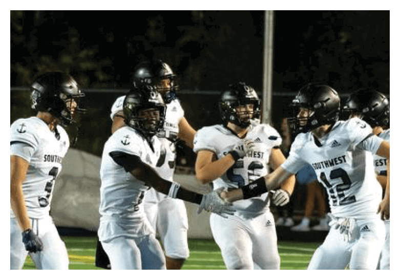 A group of football players on a field, one of them is running with a football. AI generated content