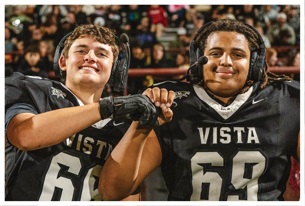 Two football players wearing black jerseys and holding hands. AI generated content