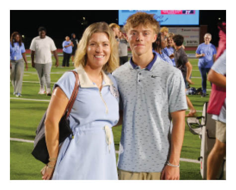 A man and woman pose for a picture on a field. AI generated content