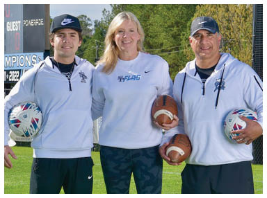 Three people are standing on a field holding footballs. AI generated content