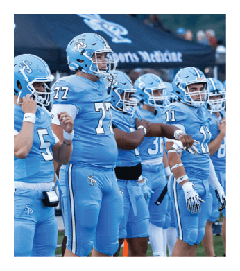 A group of football players wearing blue uniforms stand on the field. AI generated content