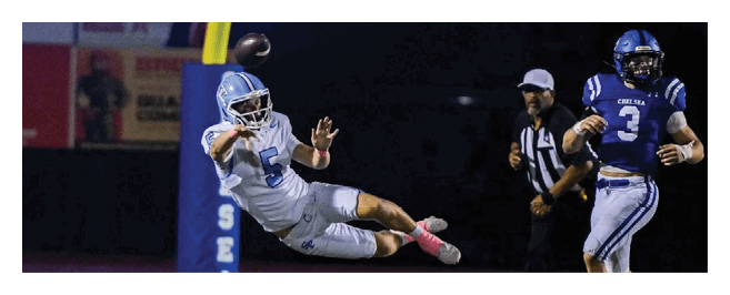 A football player dives for the ball while another player watches. AI generated content