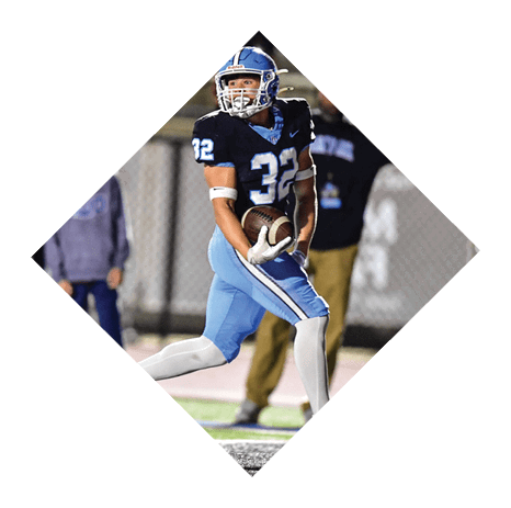 A football player wearing a blue jersey with the number 32 is running with a football. AI generated content