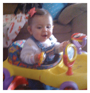 A baby girl is sitting in a toy car, smiling and playing. AI generated content