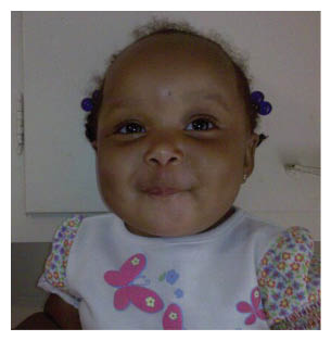 A baby wearing a bib with a flower pattern is sitting in a kitchen. AI generated content