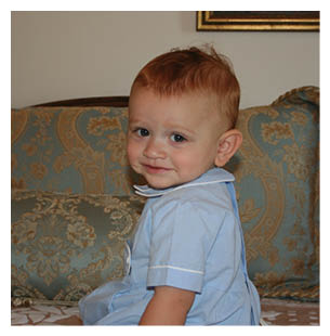 A young child wearing a blue shirt and sitting on a couch. AI generated content