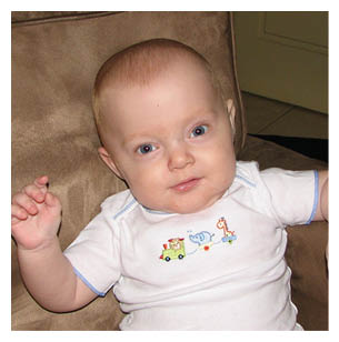 A baby is sitting on a couch wearing a white onesie. AI generated content