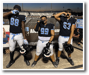 Three football players pose for a picture on the field. AI generated content