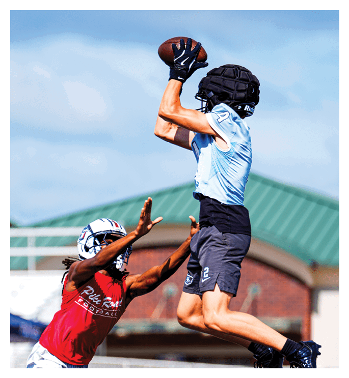 Two men playing football, one jumping to catch a ball. AI generated content