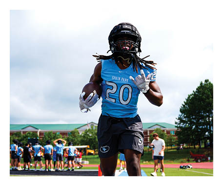 A man wearing a blue jersey with the number 20 is running on a field. AI generated content