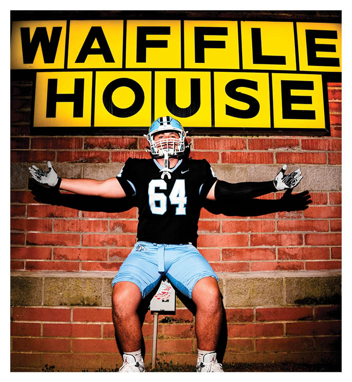 A football player wearing a helmet and jersey sits on a bench in front of a Waffle House sign. AI generated content
