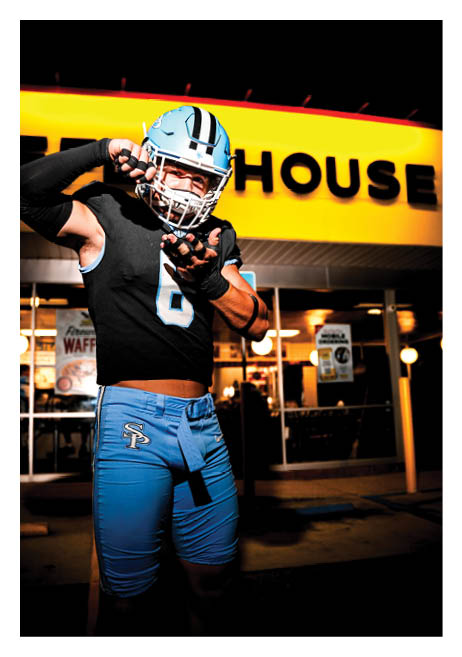 A football player wearing a blue jersey with the number 6 on it is posing in front of a restaurant. AI generated content