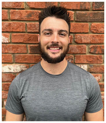 A man with a beard and mustache is smiling for the camera. AI generated content