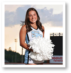 A cheerleader in a blue and white uniform stands on a football field holding a pom pom. AI generated content