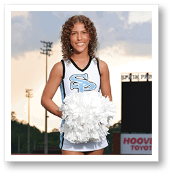 A cheerleader for the University of South Carolina stands on a football field holding a pom pom. AI generated content