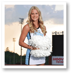 A woman in a cheerleading outfit stands on a football field holding a pom-pom. AI generated content